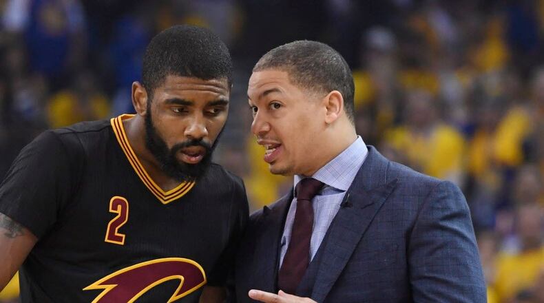 Cleveland Cavaliers head coach Tyronn Lue talks with guard Kyrie Irving (2) against the Golden State Warriors during the first quarter in game five of the 2017 NBA Finals at Oracle Arena.