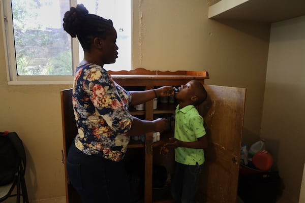 Nurse Préjuste Mexandra administers medicine to a child at the Caring for Haitian Orphans with AIDS orphanage, in Balan, Plaine-du-Nord, Haiti, Wednesday, May 21, 2025. (AP Photo/Patrice Noel)