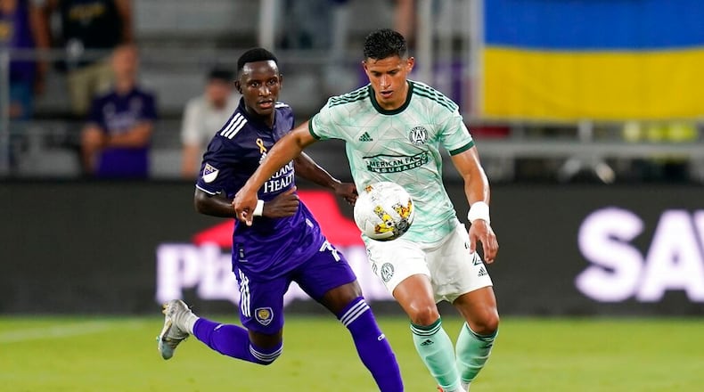 Atlanta United's Ronald Hernandez (right) tries to get position on the ball in front of Orlando City's Ivan Angulo during the second half of an MLS match Wednesday night in Orlando, Fla. (AP Photo/John Raoux)