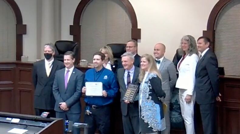 Roswell's mayor and city council join members of the Environmental/Public Works Department and Brian Skeens from the Georgia Association of Water Professionals to accept the Distribution System Excellence Gold Award. (Courtesy City of Roswell)