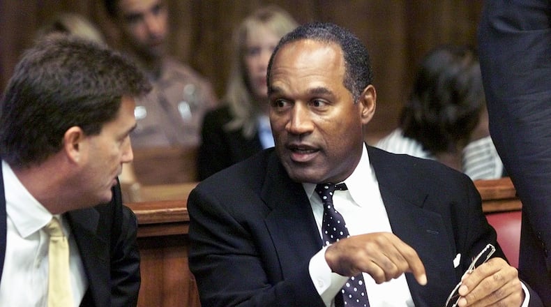 395562 04: Former NFL star O.J. Simpson talks with one of his defense attorneys on the first day of jury selection October 9, 2001 at a Dade County courtroom in Miami, FL. Simpson, who was acquitted in 1994 in the murders of his ex-wife and her friend, is on trial for allegedly attacking a motorist in the Miami suburb of Kendall, Florida in December of 2000. If found guilty, Simpson could face up to 16 years in prison. (Pool Photo/Getty Images)