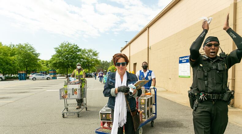 Stephanie Morales, who works in craft services for the film industry, has pivoted during the pandemic while filming has paused, to feeding first responders. She exits a local Sam’s Club with Lt. R. Palms recently. Palm had a group of firefighters, police and others gathered outside the store to thank her for her efforts. (Photos: Cindy M. Brown)