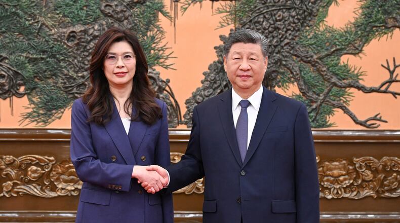 In this photo released by Xinhua News Agency, Chinese President Xi Jinping, right shakes hands with Kuomintang (KMT) party leader Cheng Li-wun in Beijing on Friday, April 10, 2026. (Xie Huanchi/Xinhua via AP)