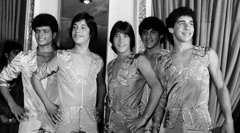 FILE - Members of the music group "Menudo," from left, Robby Rosa (Draco Rosa), Ray Reyes, Roy Roselló, Charlie Massó and Ricky Meléndez pose during a reception in their honor in New York on Feb. 10, 1984. (AP Photo/Richard Drew, File)