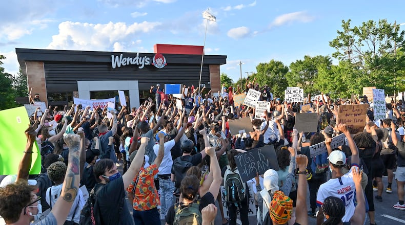 Protesters gather on Saturday, June 13, 2020, at the Atlanta Wendy's where Rayshard Brooks, a 27-year-old black man, was shot and killed by Atlanta police on Friday evening during a struggle in a Wendy's drive-thru line.  Hyosub Shin / hyosub.shin@ajc.com