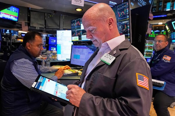 Trader Patrick Casey, center, works on the floor of the New York Stock Exchange, Thursday, May 8, 2025. (AP Photo/Richard Drew)
