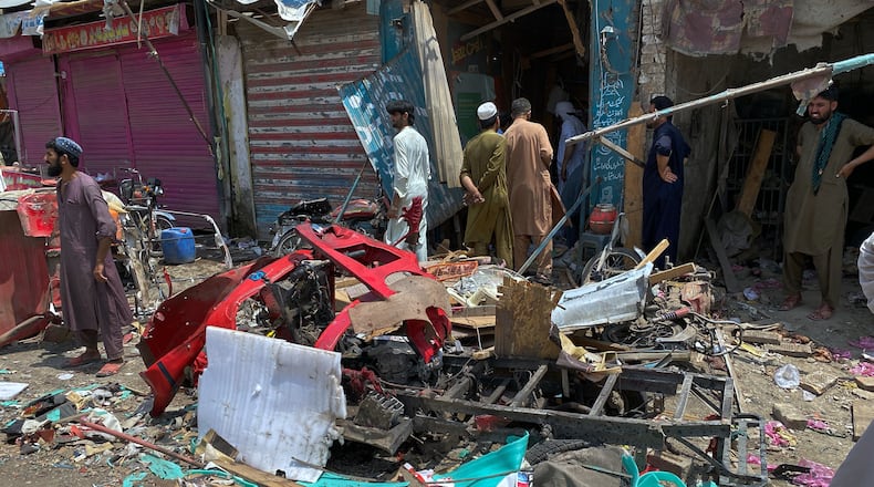 Local residents examine damage at the site of a bomb explosion at a market in Sarai Norag in Lakki Marwat, a district in Pakistan's Khyber Pakhtunkhwa province, Tuesday, May 12, 2026. (AP Photo/Farhat Ullah)