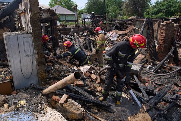Rescue workers extinguish a fire of a house destroyed by a Russian drone strike in Pryluky village, Ukraine, Thursday, June 5, 2025. (AP Photo/Evgeniy Maloletka)