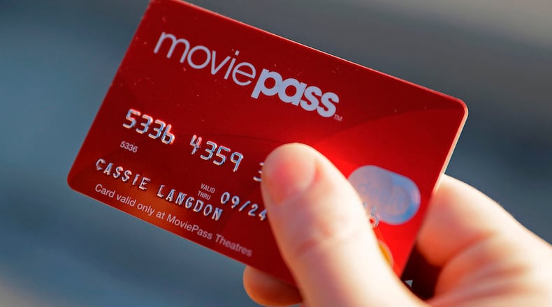 In this Jan. 30, 2018, file photo, Cassie Langdon holds her MoviePass card outside AMC Indianapolis 17 theatre in Indianapolis. MoviePass, the discount service for movie tickets, is raising prices by 50 percent and barring viewings of most major releases during the first two weeks. (AP Photo/Darron Cummings, File)