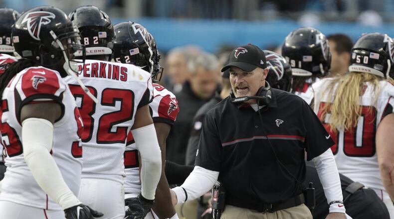 Atlanta Falcons head coach Dan Quinn greets his players on the sidelines in the second half of an NFL football game against the Carolina Panthers in Charlotte, N.C., Saturday, Dec. 24, 2016. The Falcons won 33-16. (AP Photo/Bob Leverone)