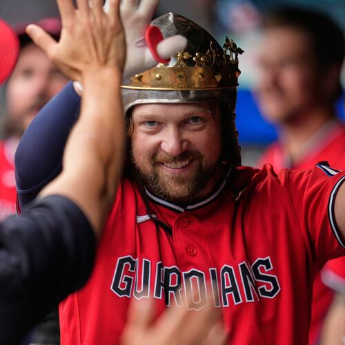 Cleveland Guardians' Rhys Hoskins celebrates in the dugout after hitting a home run in the first inning of a baseball game against the Minnesota Twins in Cleveland, Monday, July 20, 2026. (AP Photo/Sue Ogrocki)