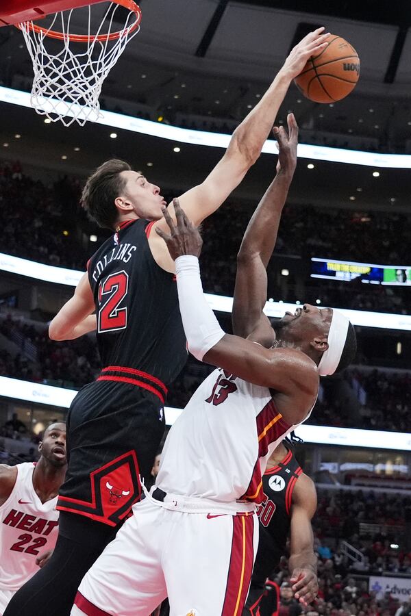 Chicago Bulls forward Zach Collins, left, blocks a shot by Miami Heat center Bam Adebayo during the first half of an NBA play-in tournament basketball game in Chicago, Wednesday, April 16, 2025. (AP Photo/Nam Y. Huh)