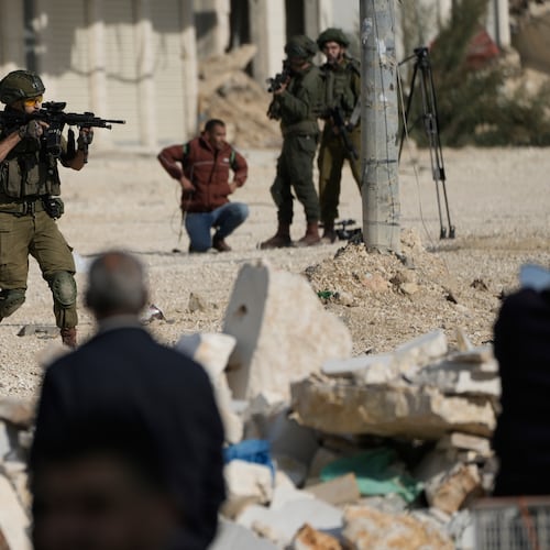 FILE - An Israeli soldier aims his weapon to disperse people taking part in a protest calling for the return of displaced Palestinians to their houses in the Nur Shams refugee camp in the West Bank city of Tulkarem, Nov. 18, 2025. (AP Photo/Majdi Mohammed, File)