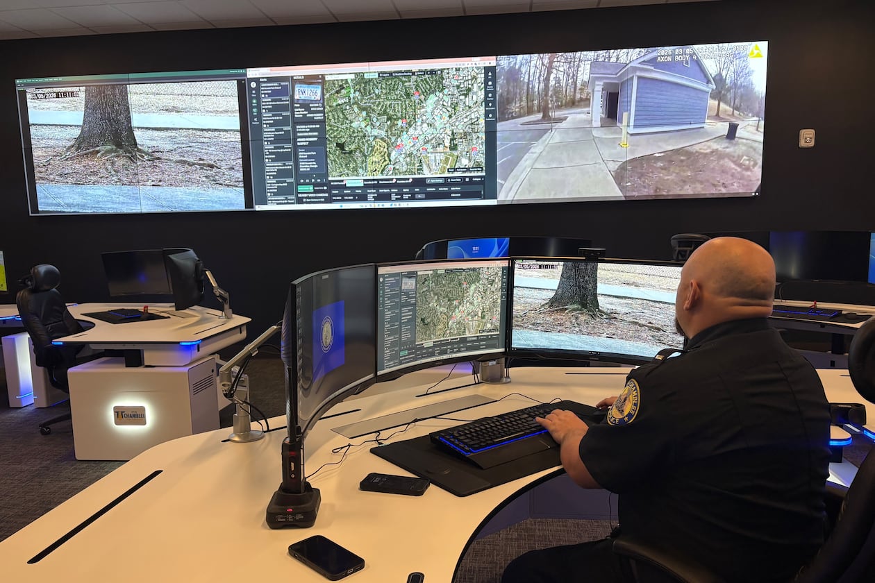 A Chamblee police officer watches surveillance feeds from the department's Real Time Crime Center. Police officials say integrated camera networks help them respond quicker to emergencies. But critics have raised privacy concerns about surveillance technology and what's being done with the data collected. (Shaddi Abusaid/AJC)