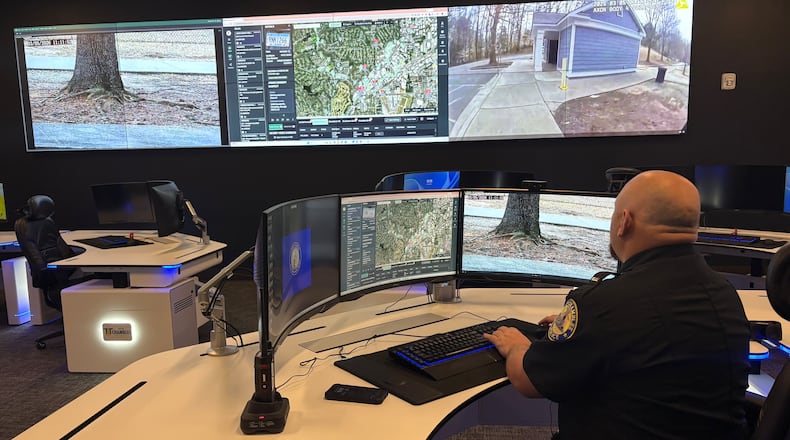 A Chamblee police officer watches surveillance feeds from the department's Real Time Crime Center. Police officials say integrated camera networks help them respond quicker to emergencies. But critics have raised privacy concerns about surveillance technology and what's being done with the data collected. (Shaddi Abusaid/AJC)