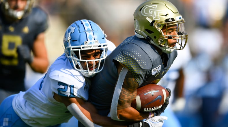 Georgia Tech's Tobias Oliver (8) runs with the ball as North Carolina linebacker Chazz Surratt (21) tackles . (Special-John Amis)