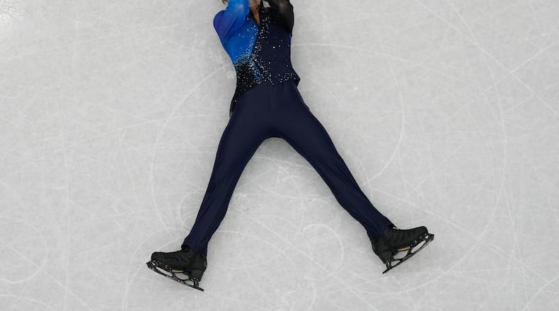 Mikhail Shaidorov of Kazakhstan reacts as he competes during the men's free skate program in figure skating at the 2026 Winter Olympics, in Milan, Italy, Friday, Feb. 13, 2026. (AP Photo/Christophe Ena)