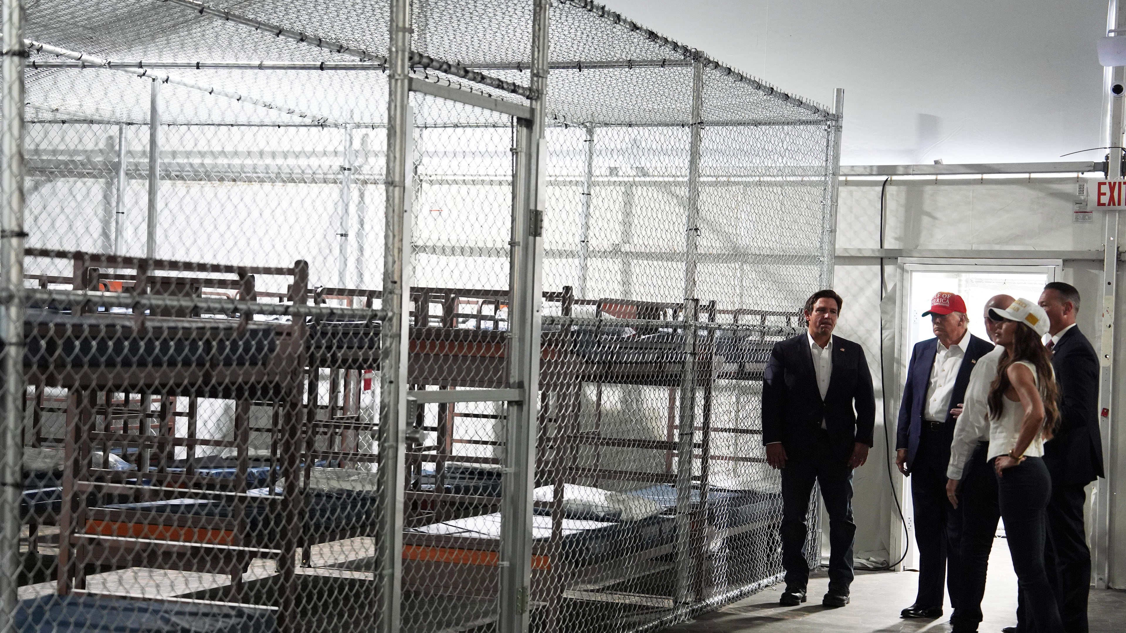 FILE - President Donald Trump, Gov. Ron DeSantis, R-Fla., and Homeland Security Secretary Kristi Noem, and others, tour "Alligator Alcatraz," a new migrant detention facility at Dade-Collier Training and Transition facility, Tuesday, July 1, 2025, in Ochopee, Fla. (AP Photo/Evan Vucci, File)
