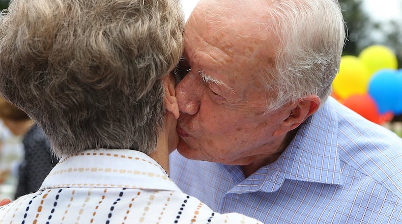 Former President Jimmy Carter gives Carol Anderson a kiss on the cheek while thanking the hometown folks one at a time in a receiving line during his 90th birthday party they threw for him at Maxine Reese Park on Sunday, Sept. 28, 2014, in Plains. The former president will be 97 on Friday, Oct. 1.  CURTIS COMPTON / CCOMPTON@AJC.COM