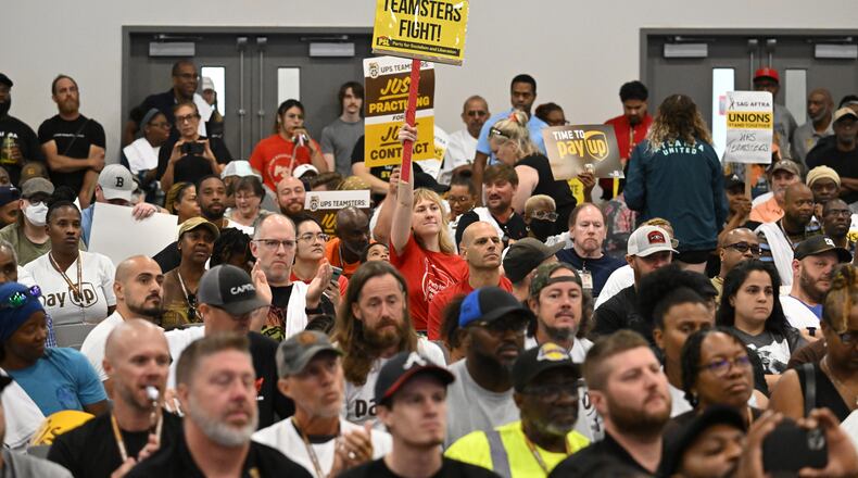 A rally participant holds a sign to show her support during a rally just days before high-stakes contract talks with UPS are set to resume, at Teamsters Local 728, Saturday, July 22, 2023, in Atlanta. The head of the International Brotherhood of Teamsters revved up the union’s membership in Atlanta on Saturday at a rally just days before high-stakes contract talks with UPS are set to resume. (Hyosub Shin / Hyosub.Shin@ajc.com)