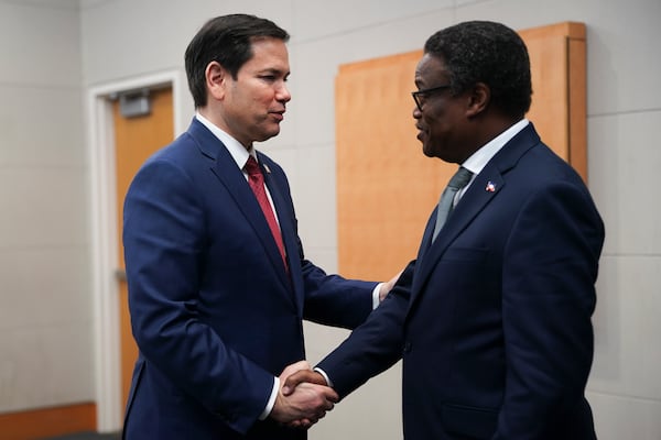 U.S. Secretary of State Marco Rubio, left, shakes hands with Head of Haiti's Transitional Presidential Council Fritz Jean during a meeting at the U.S. Embassy in Kingston, Jamaica, Wednesday, March 26, 2025. (Nathan Howard/Pool Photo via AP)
