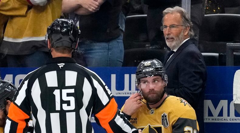 Vegas Golden Knights head coach John Tortorella, right, talks to a referee during the third period in Game 4 of the NHL hockey Stanley Cup Final series against the Carolina Hurricanes, Tuesday, June 9, 2026, in Las Vegas. (AP Photo/John Locher)