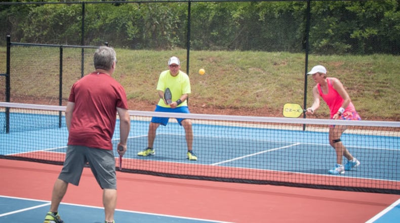 Pickleball, which is played with two or four players hitting a perforated plastic ball over a net with a paddle, is a fast-growing sport.