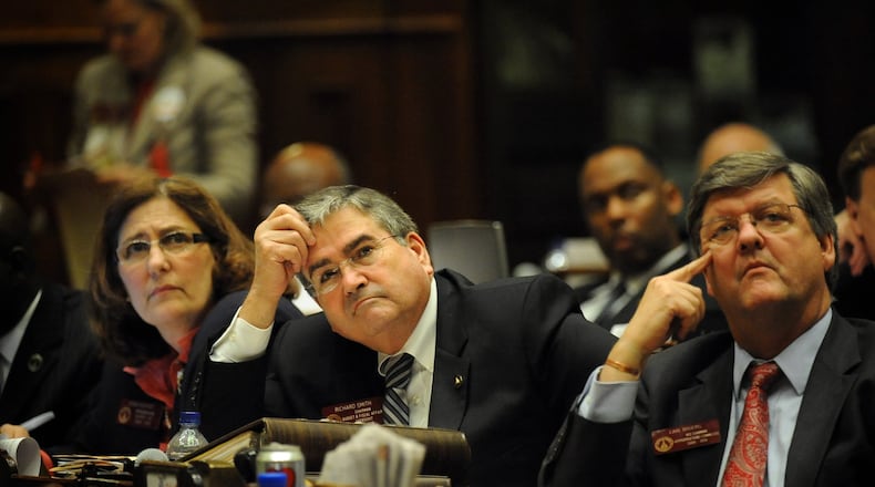 The death of state House Rules Chairman Richard Smith (center), was announced Tuesday at the Georgia Capitol. First elected as a state representative from Columbus in 2004, Smith, died from the flu. HYOSUB SHIN / HSHIN@AJC.COM