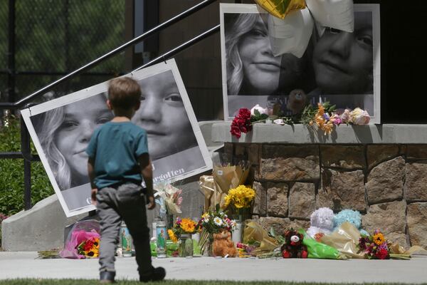 FILE - A boy looks at a memorial for Tylee Ryan and Joshua "JJ" Vallow in Rexburg, Idaho, on June 11, 2020. (John Roark/The Idaho Post-Register via AP, File)