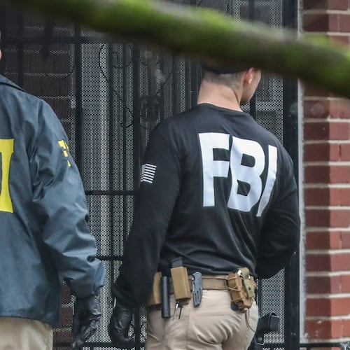 FBI agents work the scene of a search in this 2023 file photo. FBI agents have been directed to de-emphasize investigating white-collar crime, fraud and corruption in favor of assisting with transporting immigrants for ICE. (John Spink/AJC)