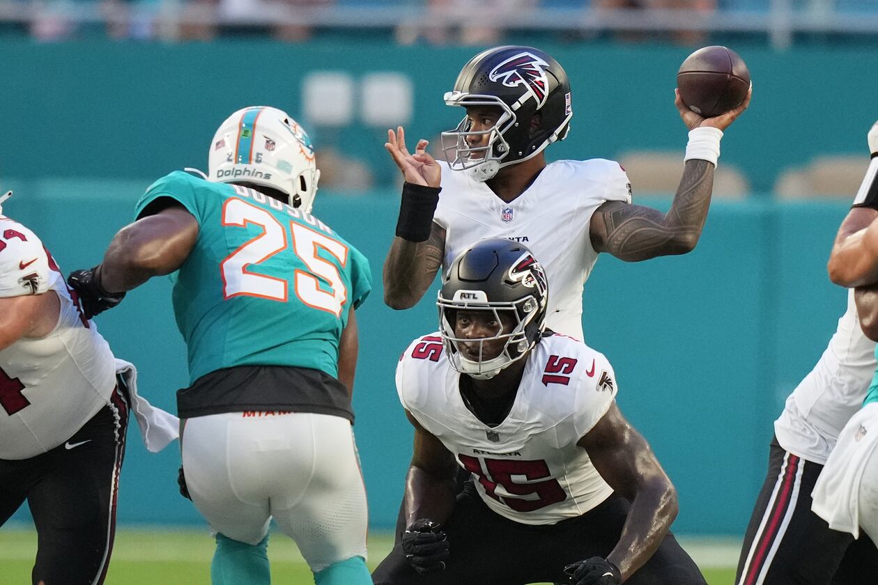Falcons quarterback Tua Tagovailoa (back) looks to throw as running back Brian Robinson Jr. readies to block Dolphins linebacker Tyrel Dodson during their NFL exhibition game on Friday, Aug. 28, 2026, in Miami Gardens, Fla. (Lynne Sladky/AP)