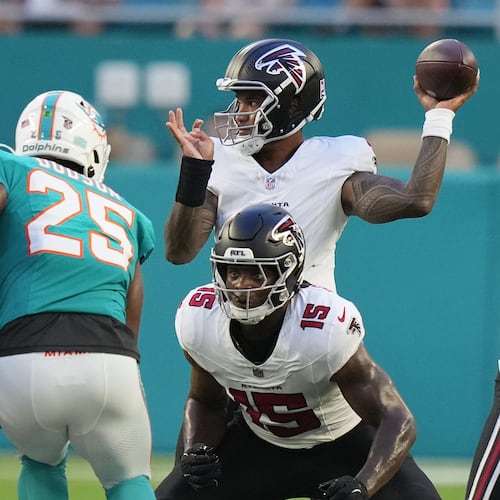 Falcons quarterback Tua Tagovailoa (back) looks to throw as running back Brian Robinson Jr. readies to block Dolphins linebacker Tyrel Dodson during their NFL exhibition game on Friday, Aug. 28, 2026, in Miami Gardens, Fla. (Lynne Sladky/AP)