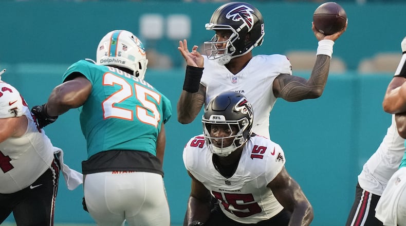 Falcons quarterback Tua Tagovailoa (back) looks to throw as running back Brian Robinson Jr. readies to block Dolphins linebacker Tyrel Dodson during their NFL exhibition game on Friday, Aug. 28, 2026, in Miami Gardens, Fla. (Lynne Sladky/AP)