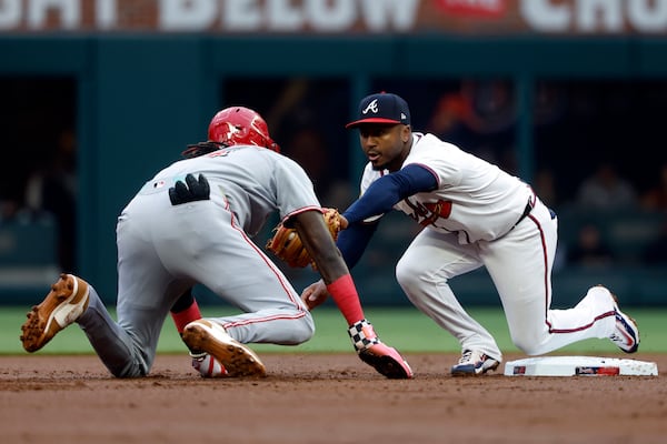 Braves second baseman Ozzie Albies prepares to wrestle — I mean tag — Reds shortstop Elly De La Cruz after De La Cruz slid past the base Wednesday.
