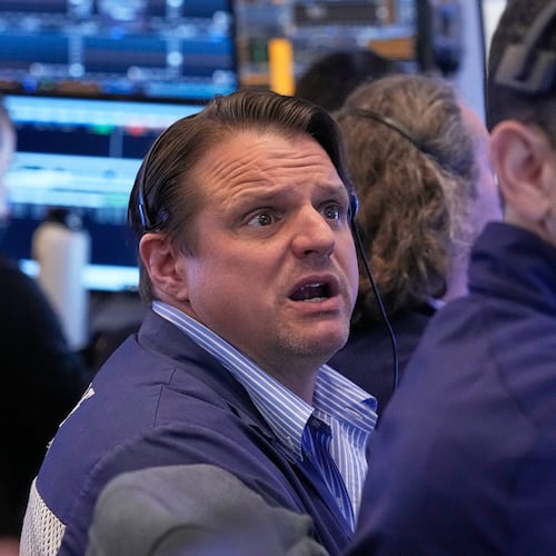 Trader Michael Milano, left, works on the floor of the New York Stock Exchange, Monday, April 20, 2026. (AP Photo/Richard Drew)