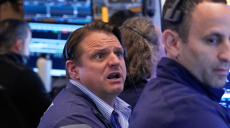 Trader Michael Milano, left, works on the floor of the New York Stock Exchange, Monday, April 20, 2026. (AP Photo/Richard Drew)