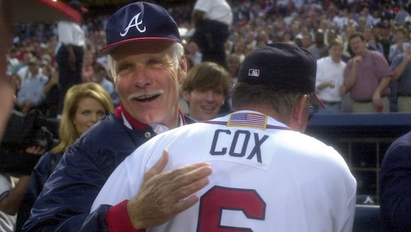 Longtime Atlanta Braves owner Ted Turner congratulates manager Bobby Cox following their 6-2 win over the Houston Astros in Game 3 of the National League Division Series on Friday, Oct. 12, 2001. The two franchise icons died last week. (Marlene Karas/AJC 2001)