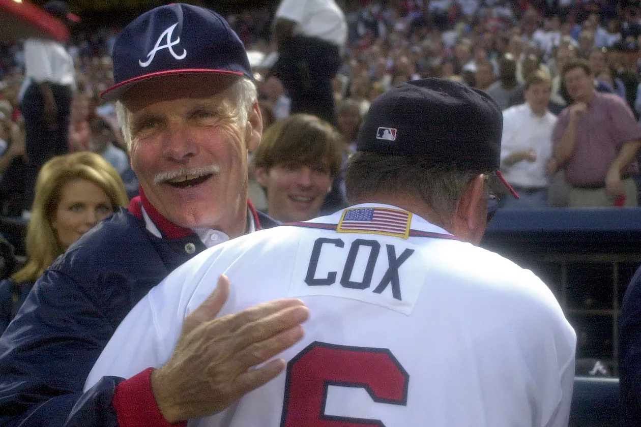 Longtime Braves owner Ted Turner (back) congratulates manager Bobby Cox on a win in the 2001 National League Division Series. (Marlene Karas/AJC 2001)