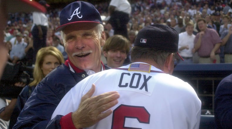 Longtime Braves owner Ted Turner (back) congratulates manager Bobby Cox on a win in the 2001 National League Division Series. (Marlene Karas/AJC 2001)