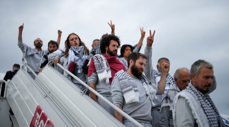 Activists from the Global Sumud Flotilla disembark a plane upon arriving at Istanbul Airport, in Istanbul, Turkey, Thursday, May 21, 2026. (AP Photo/Emrah Gurel)