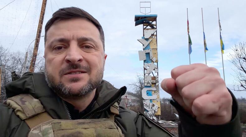 In this grab from a video provided by the Press Service Of The President Of Ukraine on Friday, Dec 12, 2025, Ukraine's President Volodymyr Zelenskyy records a video at the road entering of Kupiansk, Ukraine. (Press Service Of The President Of Ukraine via AP)