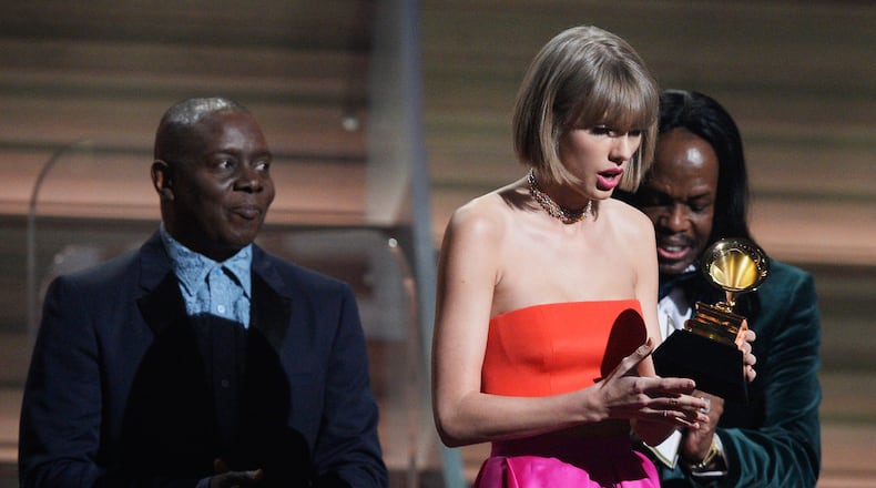 LOS ANGELES, CA - FEBRUARY 15: Singer Taylor Swift (C) accepts the Album of the Year award for "1989" onstage from musicians Philip Bailey (L) and Verdine White of Earth, Wind & Fire during The 58th GRAMMY Awards at Staples Center on February 15, 2016 in Los Angeles, California. (Photo by Kevork Djansezian/Getty Images for NARAS)