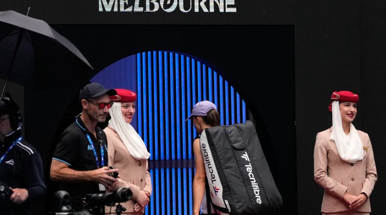 Iga Swiatek of Poland walks from the court following her quarterfinal loss to Elena Rybakina of Kazakhstan at the Australian Open tennis championship in Melbourne, Australia, Wednesday, Jan. 28, 2026. (AP Photo/Aaron Favila)