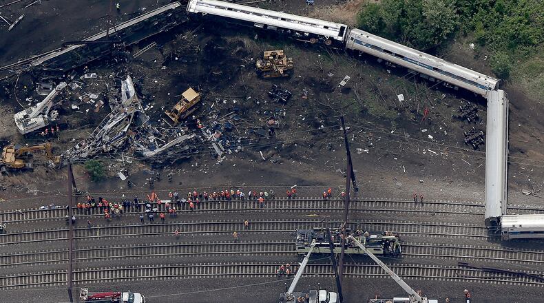 FATAL TRAIN DERAILMENT--PHILADELPHIA, PA - MAY 13: Investigators and first responders work near the wreckage of Amtrak Northeast Regional Train 188, from Washington to New York, that derailed yesterday May 13, 2015 in north Philadelphia, Pennsylvania. At least six people were killed and more than 200 others were injured in the crash. (Photo by Win McNamee/Getty Images)