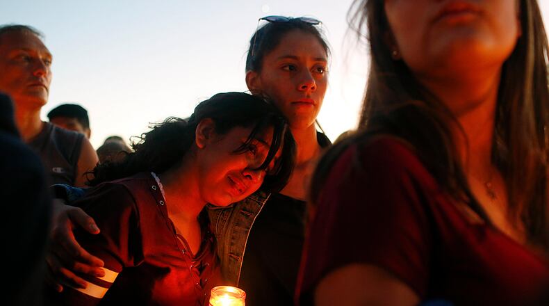 Students gather during a vigil at Pine Trails Park for the victims of the Wednesday shooting at Marjory Stoneman Douglas High School, in Parkland, Fla., Thursday, Feb. 15, 2018. Nikolas Cruz, accused of using a semi-automatic rifle in a shooting at a Florida high school, confessed to carrying out the killing and carried extra ammunition in his backpack, according to a sheriff's department report released Thursday. (AP Photo/Brynn Anderson)
