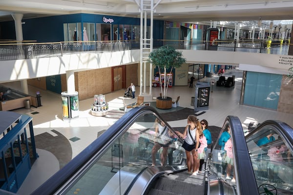 Shoppers ride up an escalator at North Point Mall in Alpharetta on April 10, 2026. (Arvin Temkar/AJC)