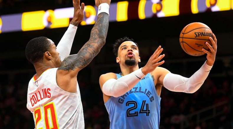 Memphis Grizzlies guard Dillon Brooks (24) shoots as Atlanta Hawks forward John Collins defends during the first half of Monday's game in Atlanta. (AP Photo/John Amis)