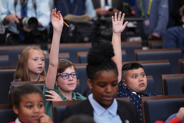 Children raised their hands as White House press secretary Karoline Leavitt speaks during a briefing for "Take Our Sons and Daughters To Work Day" at the White House, Tuesday, May 20, 2025, in Washington. (AP Photo/Evan Vucci)