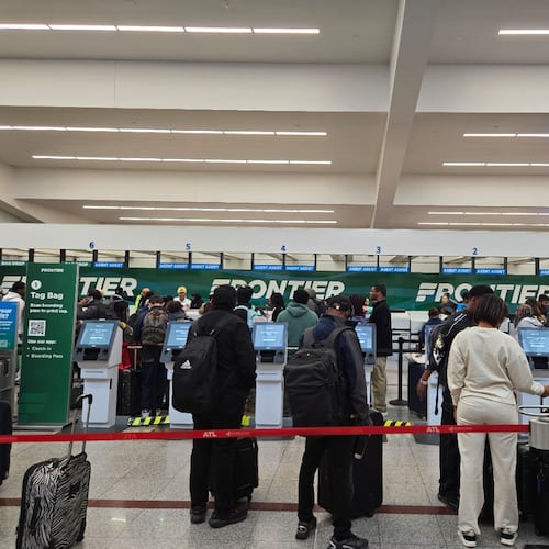 Passengers wait to check in or drop off luggage at the Frontier Airlines counter around lunchtime Sunday, Nov. 30, 2025. More than 100,000 travelers were expected to fly out of Hartsfield-Jackson Atlanta International Airport on Sunday. (Maya T. Prabhu/AJC)
