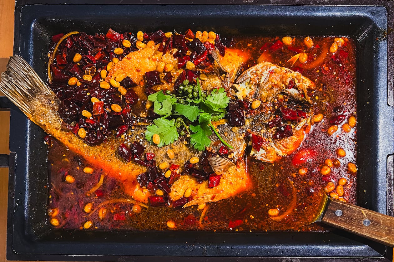 A dish at Jiang Nan described simply as grilled fish offers a spectacular whole fish, seen here swimming in Chongqing-style pepper sauce. (Henri Hollis/AJC)